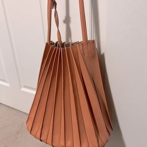 Peach colored accordion purse